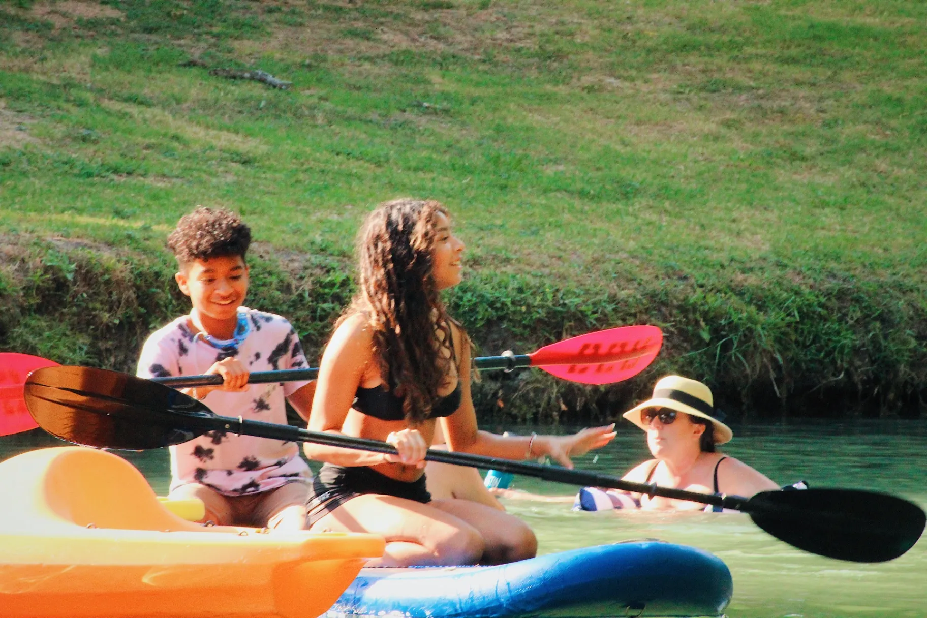 Teens kayaking on Geronimo Creek