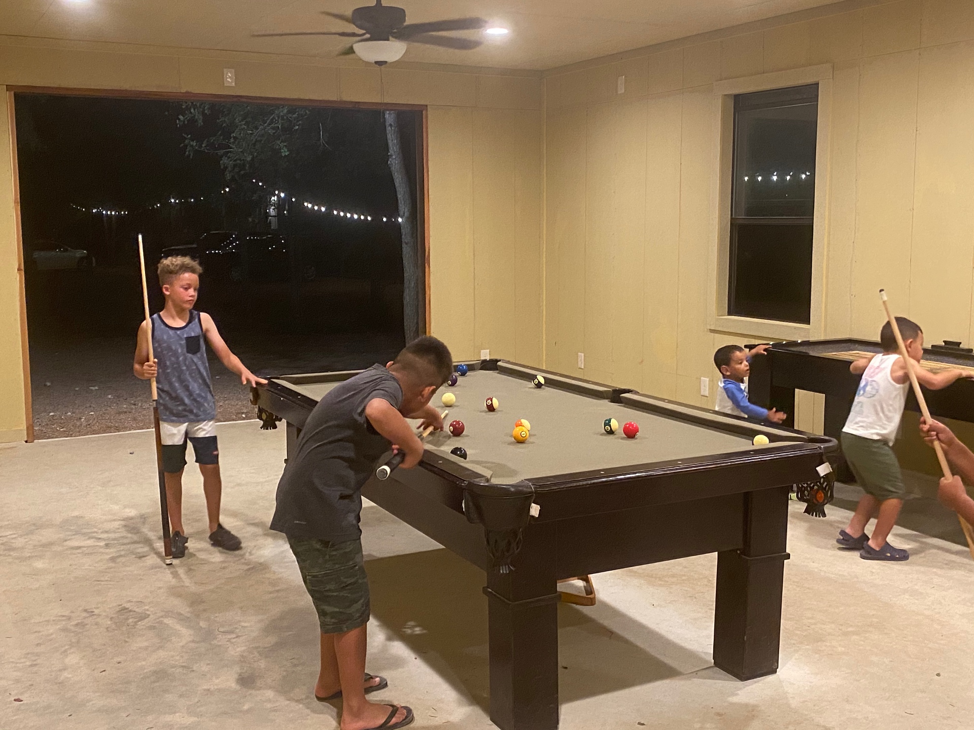 Kids playing pool in the game room