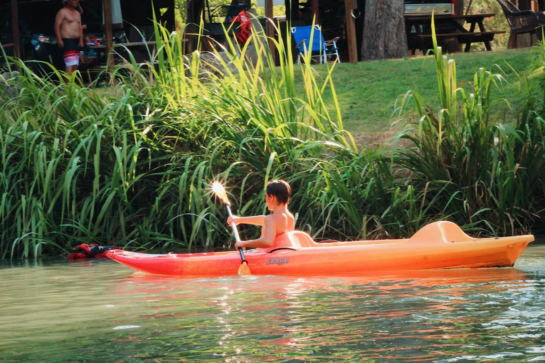 Boy kayaking on the creek