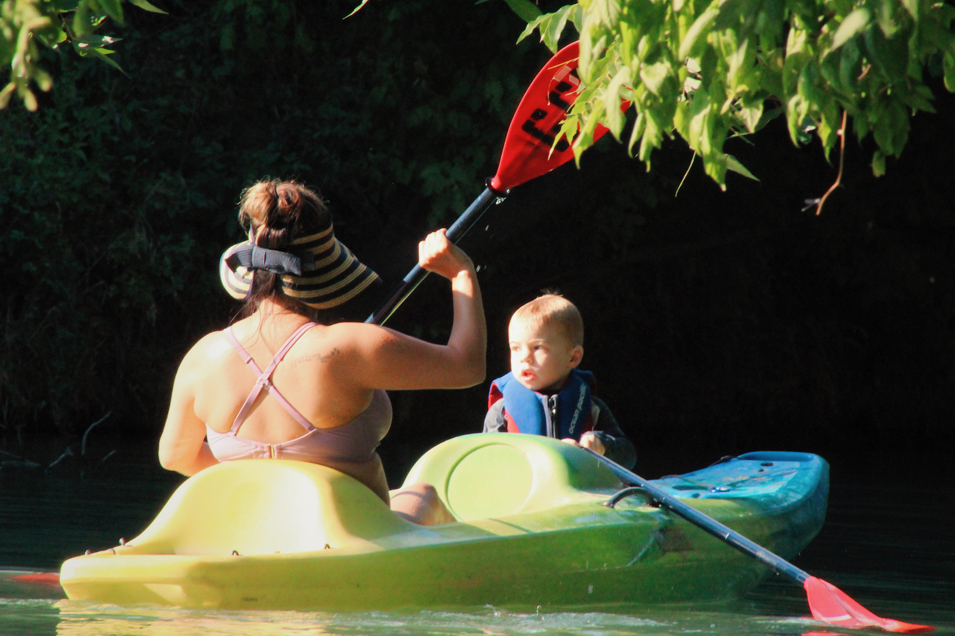 Mom and son kayaking on the creek