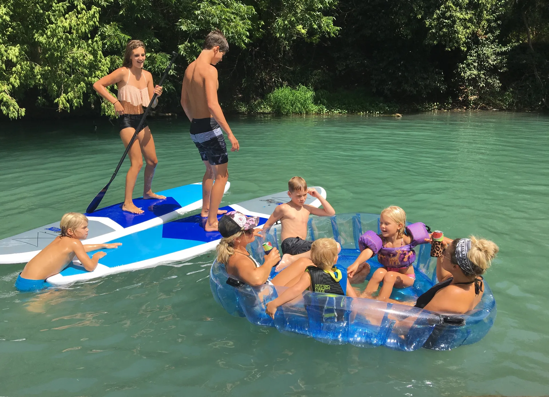 Family wading and playing in shallow Geronimo Creek near New Braunfels