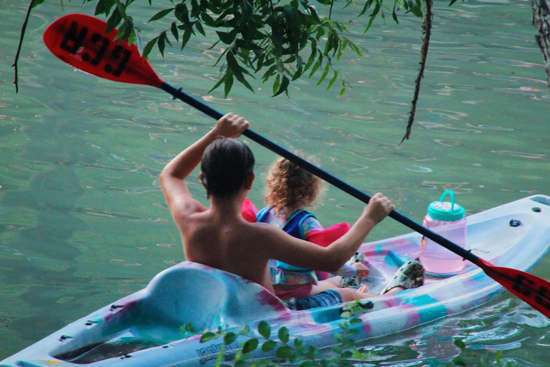 Dad and child kayaking on Geronimo Creek — glamping near San Antonio at Son's Geronimo